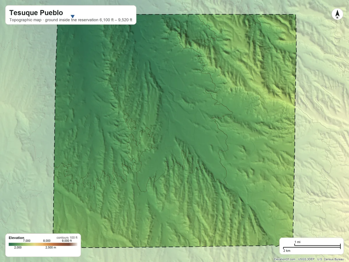 Topographic elevation map of Tesuque Pueblo, New Mexico, shaded from 6,100 ft on the northwest side to 9,520 ft on the east side