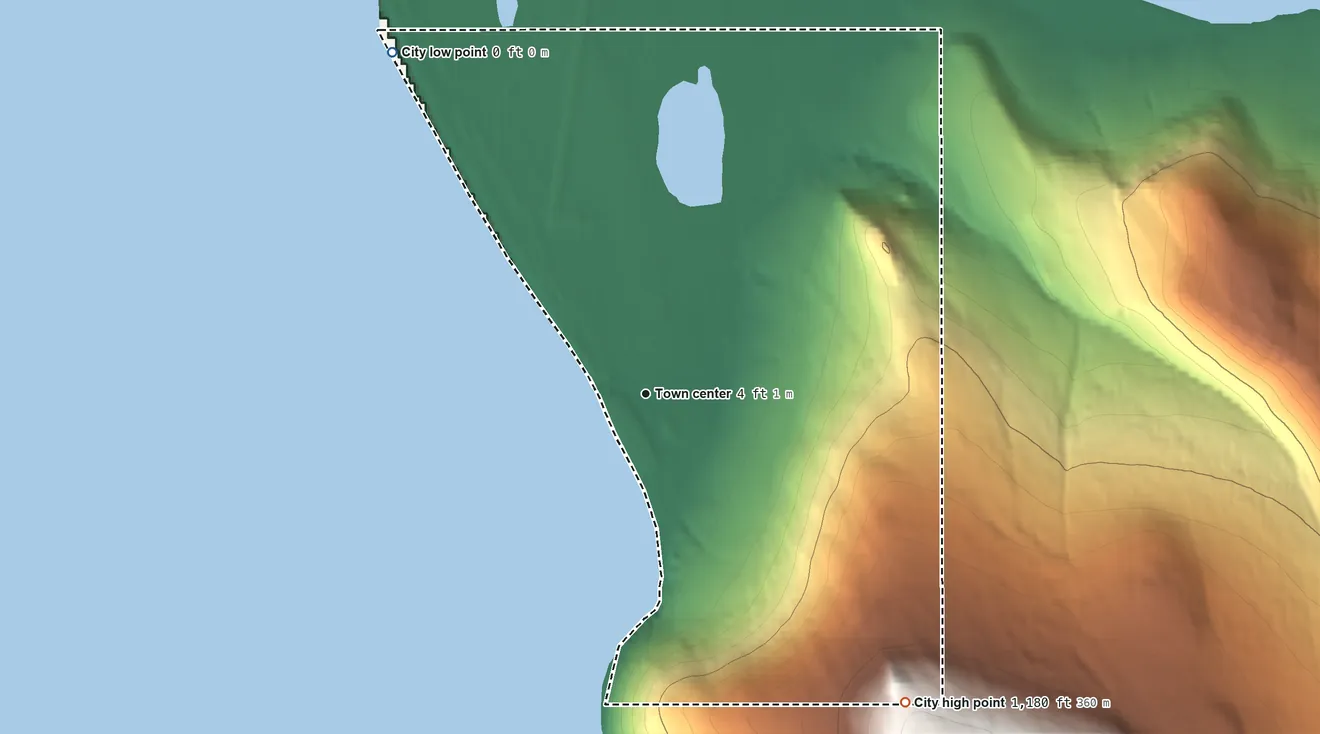 Topographic elevation map of Wales, Alaska, shaded from sea level level on the Chukchi Sea to 1,180 ft on the southeast edge, below higher ground just outside