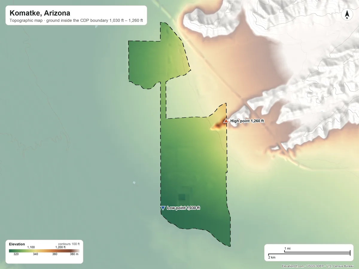 Topographic elevation map of Komatke, Arizona, shaded from 1,030 ft on the south side to 1,260 ft at the foot of the Gila Range