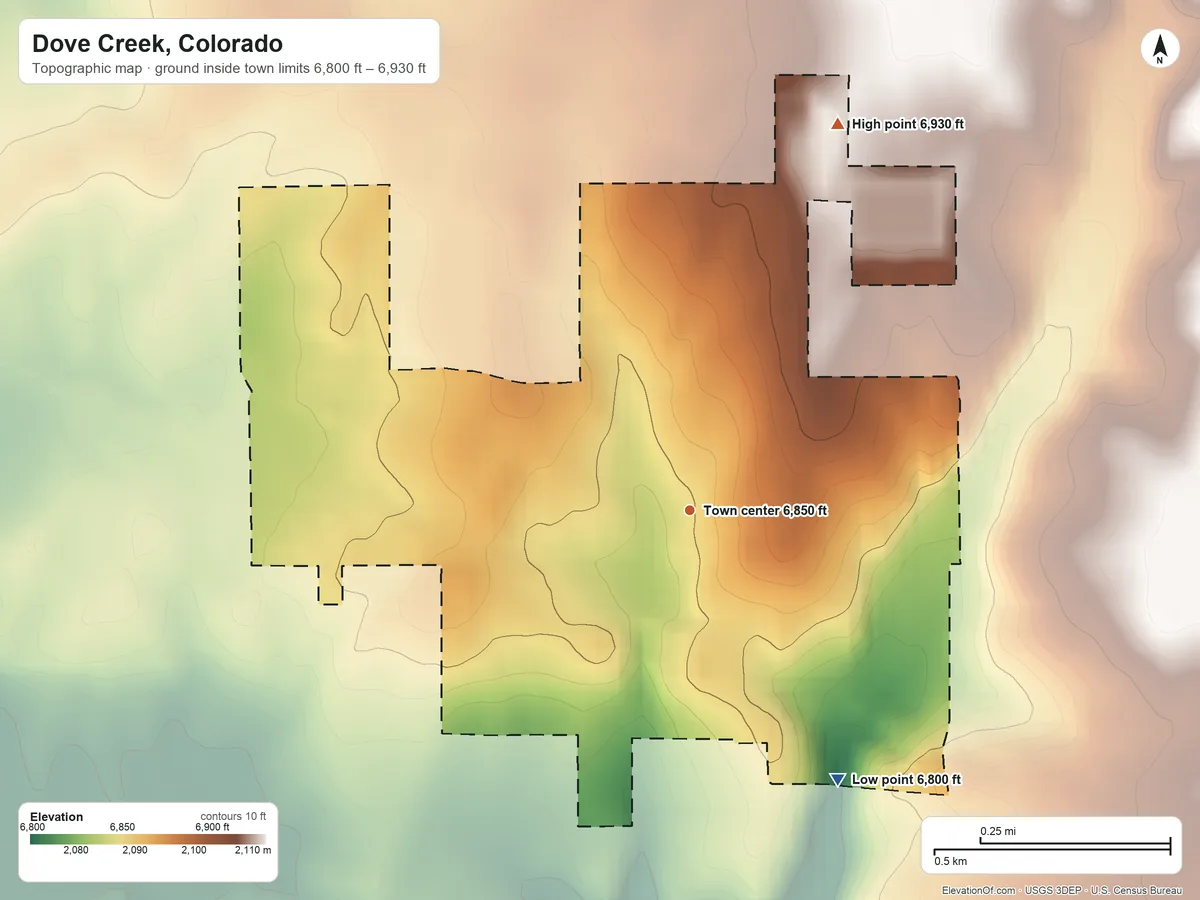 Topographic elevation map of Dove Creek, Colorado, shaded from 6,800 ft on the southeast side to 6,930 ft on the north side