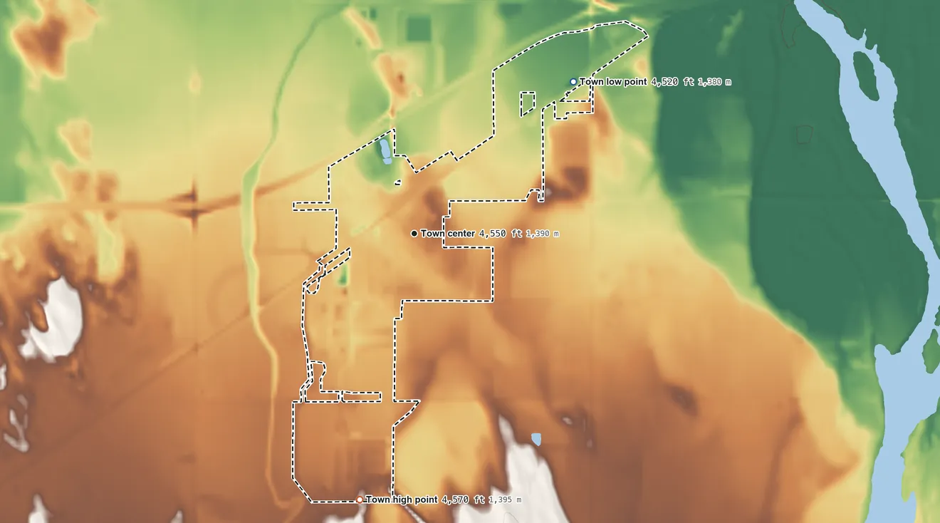 Topographic elevation map of Wiggins, Colorado, shaded from 4,520 ft on the northeast side to 4,570 ft on the south side