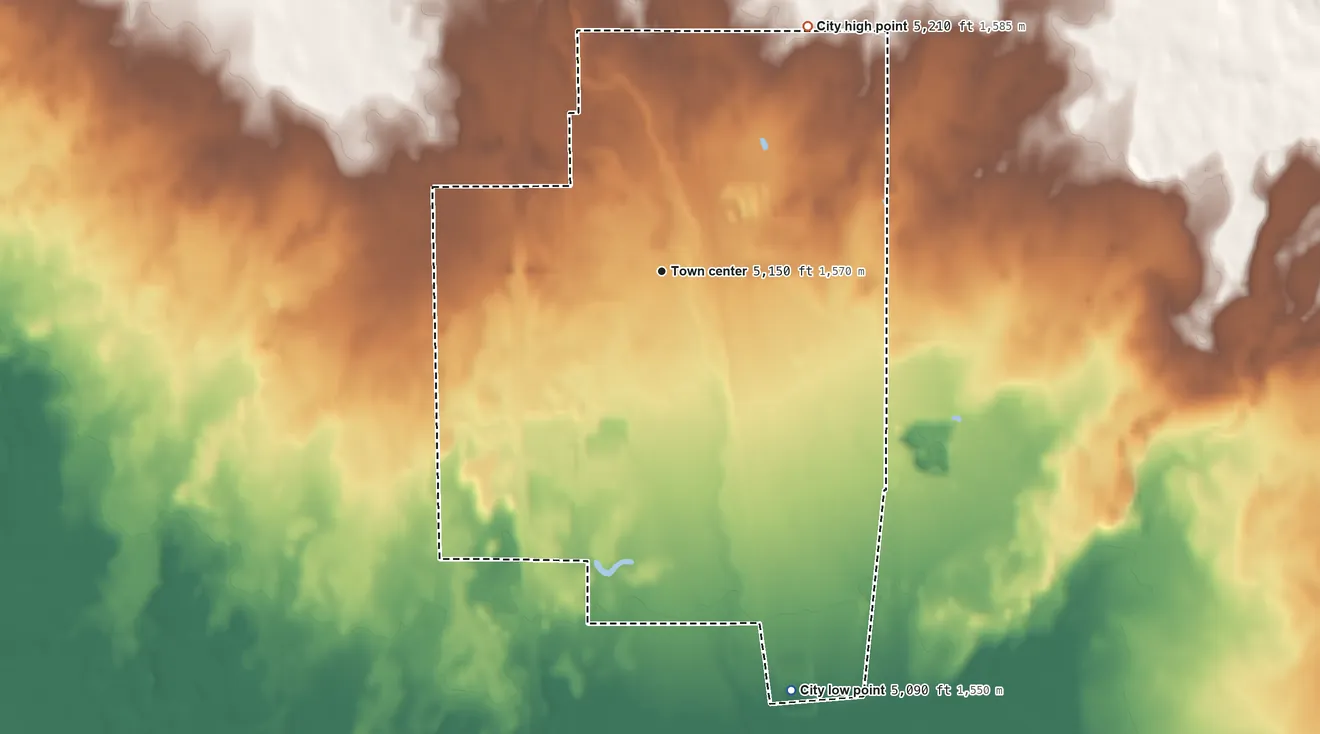 Topographic elevation map of Dubois, Idaho, shaded from 5,090 ft on the south side to 5,210 ft on the northeast side