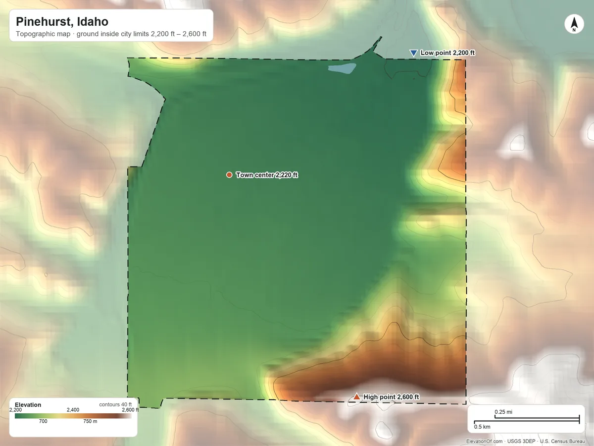 Topographic elevation map of Pinehurst, Idaho, shaded from 2,200 ft on the northeast side to 2,600 ft on the southeast edge, below higher ground just outside