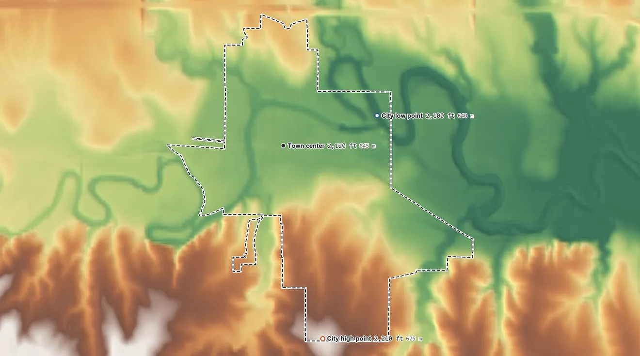 Topographic elevation map of Ellis, Kansas, shaded from 2,100 ft on the east side to 2,210 ft on the south side