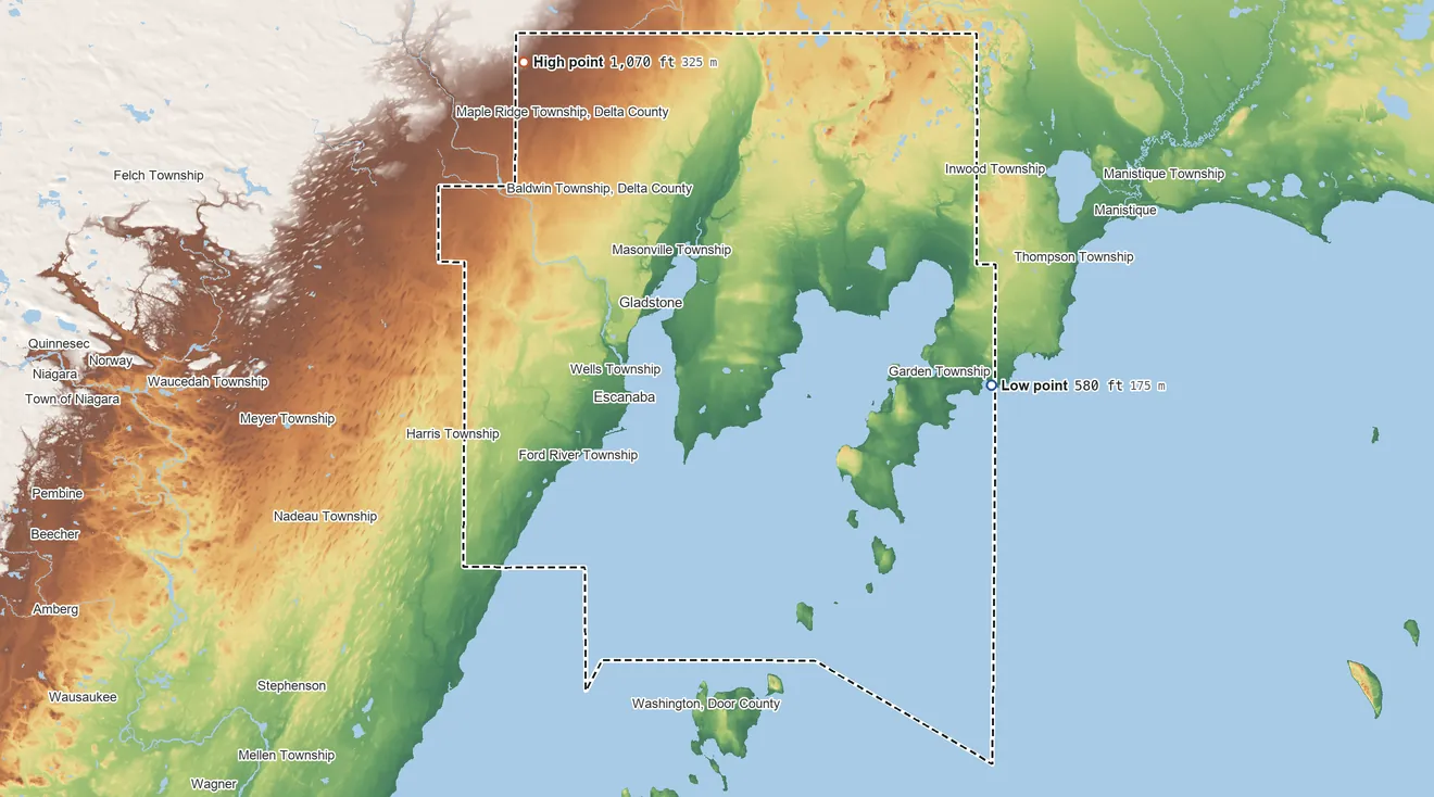Topographic elevation map of Delta County, Michigan, shaded from 580 ft on the shore of Lake Michigan to 1,070 ft on the northwest side