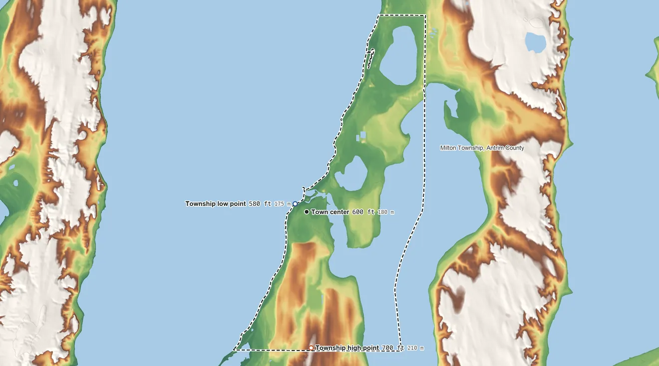 Topographic elevation map of Elk Rapids Township, Michigan, shaded from 580 ft near the middle to 700 ft on the south side