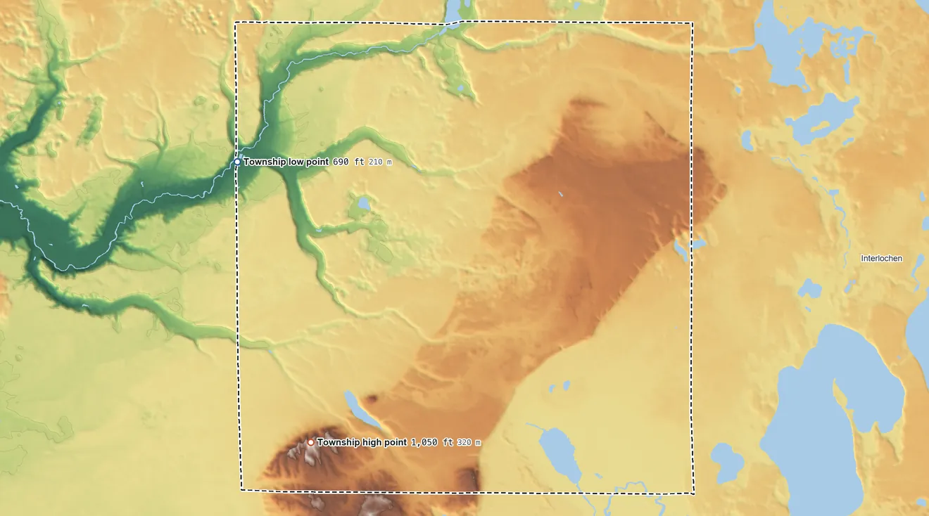 Topographic elevation map of Inland Township, Michigan, shaded from 690 ft on the west side to 1,050 ft on Turtle Lake Hill