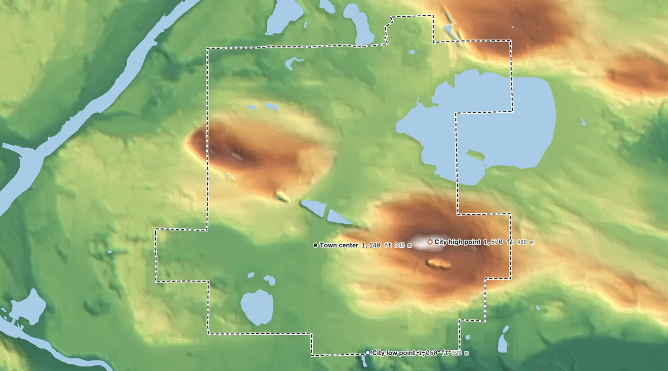 Topographic elevation map of Iron Mountain, Michigan, shaded from 1,050 ft on the southeast side to 1,570 ft on Millie Hill