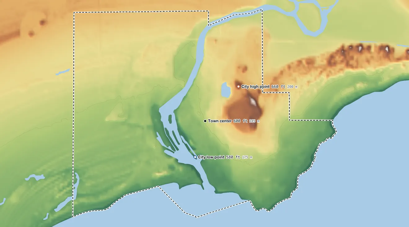Topographic elevation map of Manistique, Michigan, shaded from 580 ft on the shore of Lake Michigan to 660 ft on the northeast side