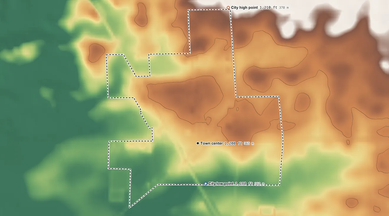 Topographic elevation map of Gilman, Minnesota, shaded from 1,180 ft on the south side to 1,210 ft on the north side