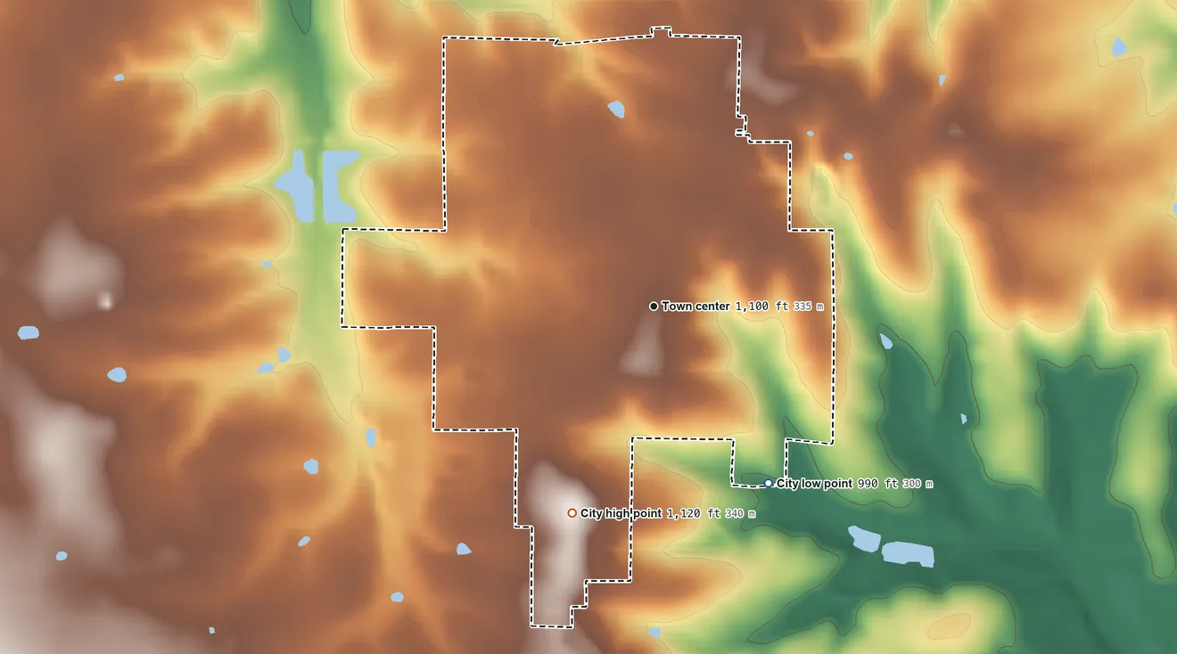 Topographic elevation map of Greenfield, Missouri, shaded from 990 ft on the southeast side to 1,120 ft on the south side