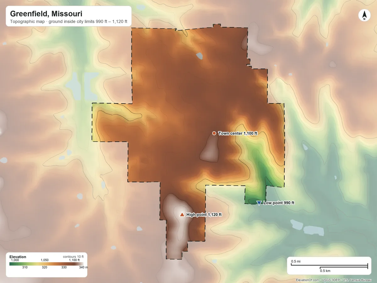 Topographic elevation map of Greenfield, Missouri, shaded from 990 ft on the southeast side to 1,120 ft on the south side