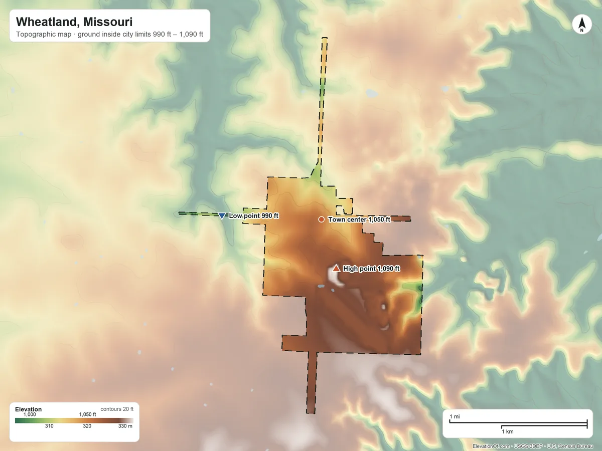 Topographic elevation map of Wheatland, Missouri, shaded from 990 ft on the west side to 1,090 ft on the south side