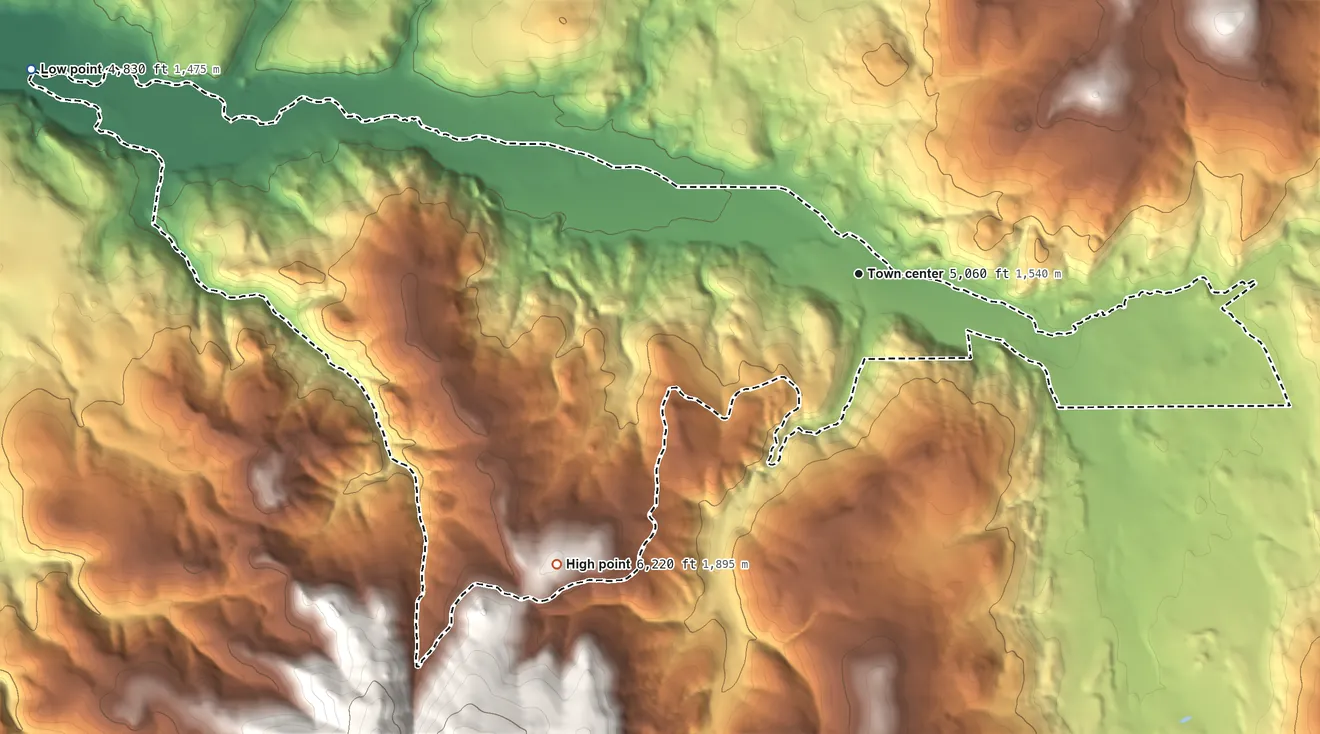 Topographic elevation map of Elliston, Montana, shaded from 4,830 ft on the west side to 6,220 ft at the foot of the General Eisenhower Range (not official)