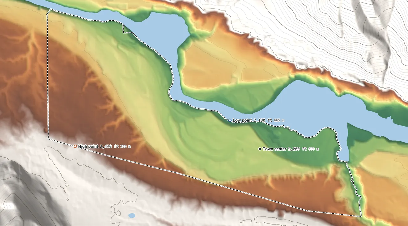 Topographic elevation map of Heron, Montana, shaded from 2,180 ft on the northwest side to 2,470 ft on the west edge, below higher ground just outside