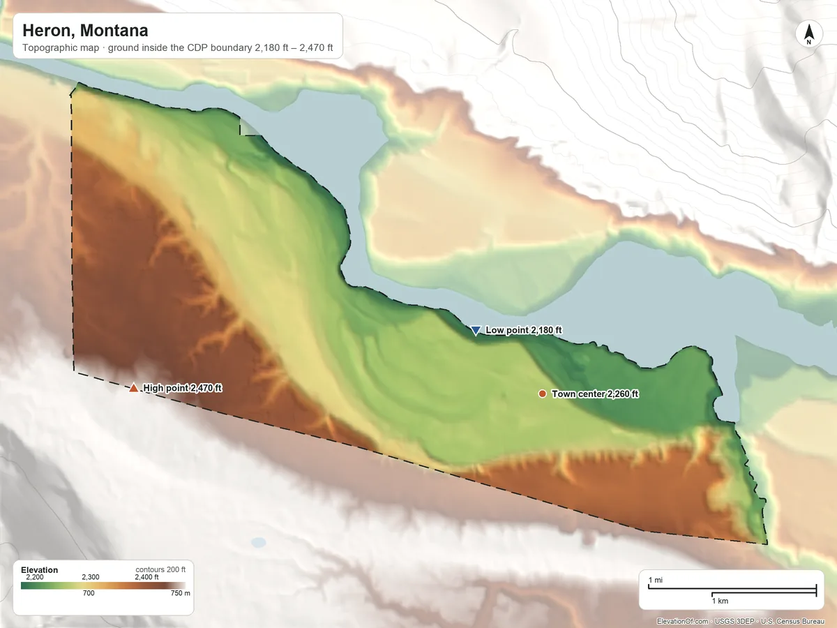 Topographic elevation map of Heron, Montana, shaded from 2,180 ft on the northwest side to 2,470 ft on the west edge, below higher ground just outside
