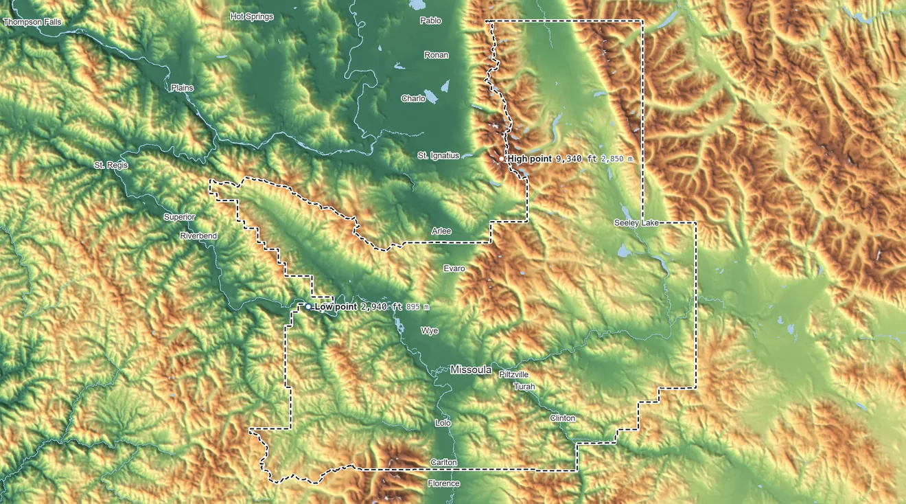 Topographic elevation map of Missoula County, Montana, shaded from 2,940 ft on the west side to 9,340 ft on Lowary Peak