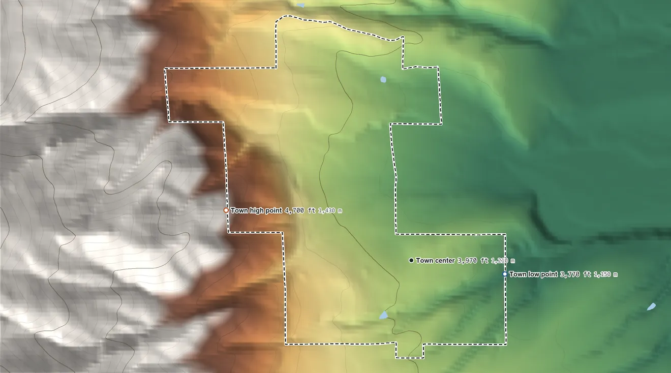 Topographic elevation map of Pinesdale, Montana, shaded from 3,770 ft on the east side to 4,700 ft on the west edge, below higher ground just outside