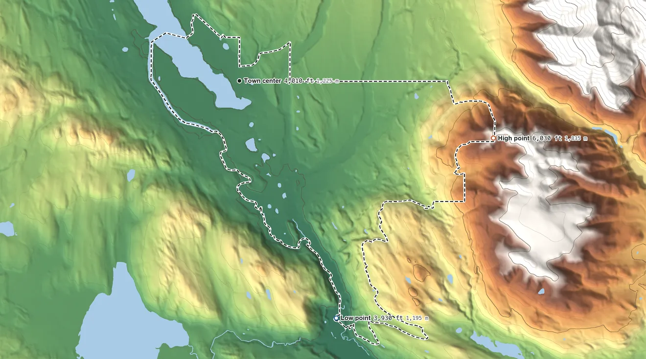 Topographic elevation map of Seeley Lake, Montana, shaded from 3,930 ft on the south side to 6,030 ft on the east edge, below higher ground just outside