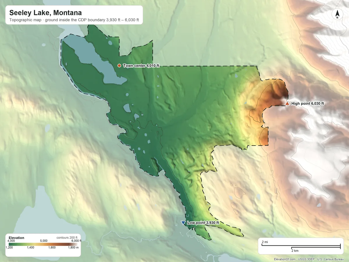 Topographic elevation map of Seeley Lake, Montana, shaded from 3,930 ft on the south side to 6,030 ft on the east edge, below higher ground just outside