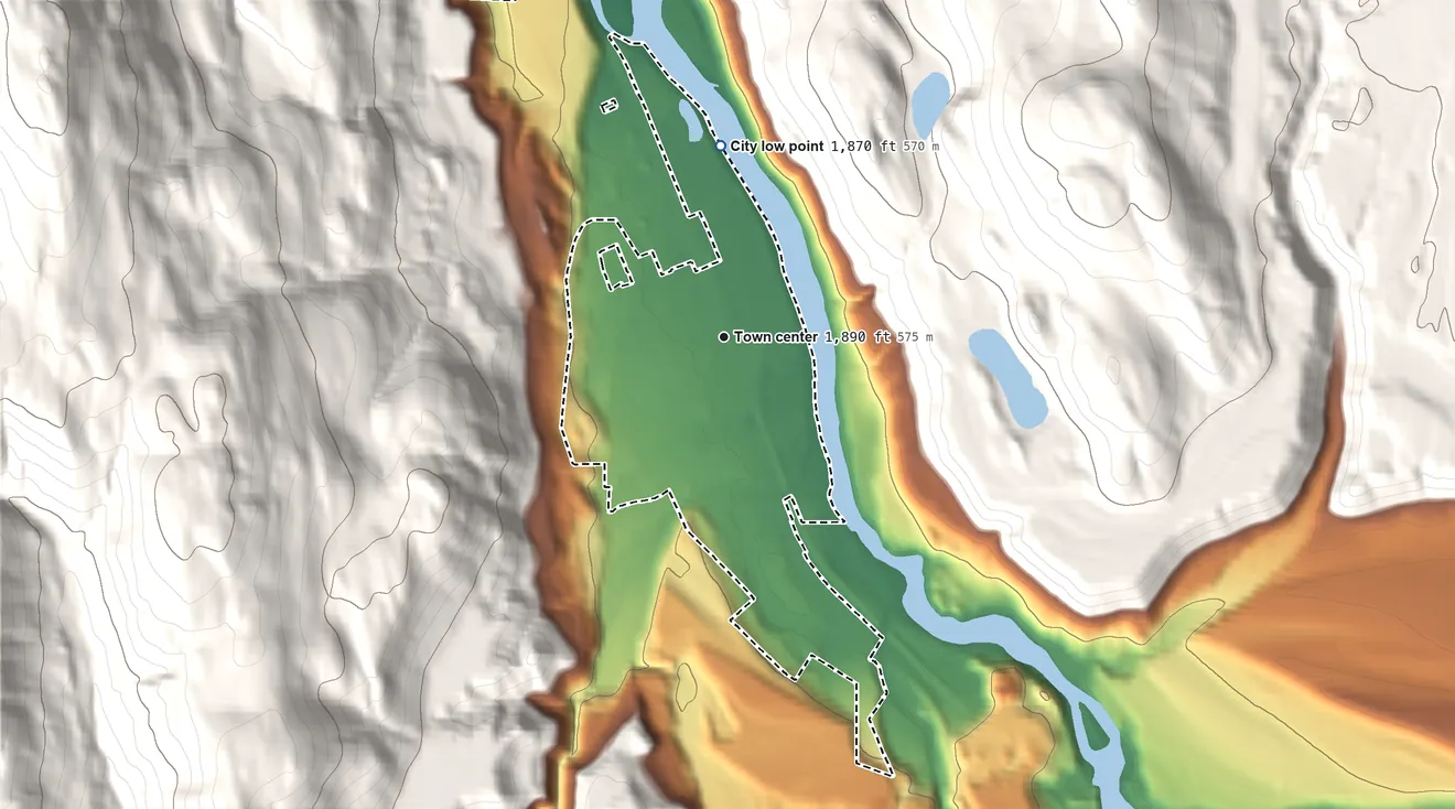 Topographic elevation map of Troy, Montana, shaded from 1,870 ft on the north side to 2,220 ft on the northwest edge, below higher ground just outside