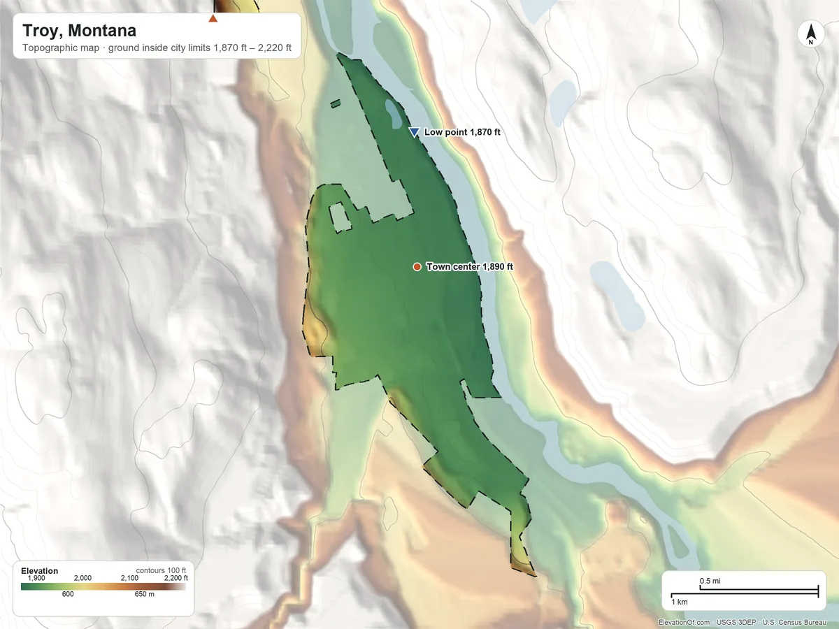 Topographic elevation map of Troy, Montana, shaded from 1,870 ft on the north side to 2,220 ft on the northwest edge, below higher ground just outside