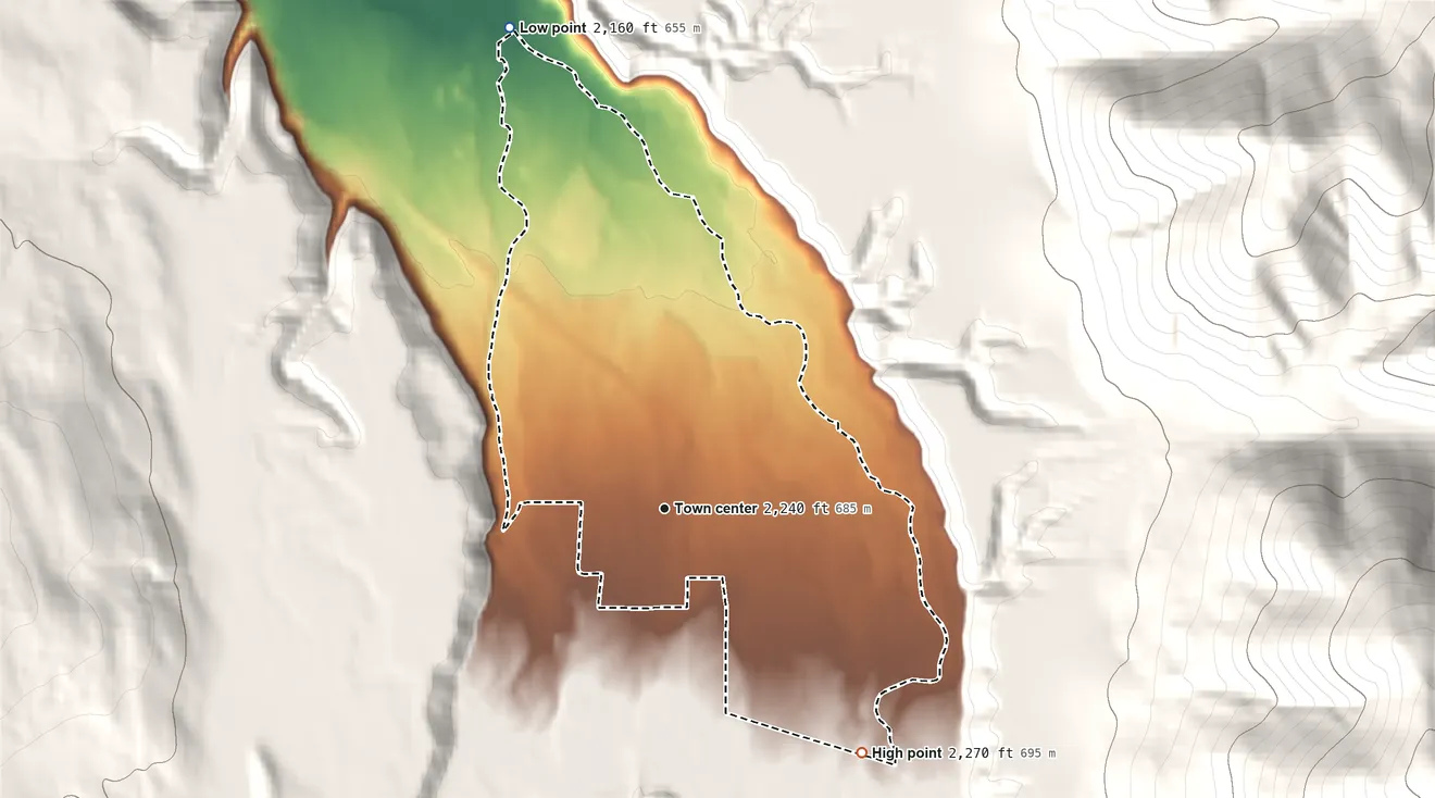 Topographic elevation map of White Haven, Montana, shaded from 2,160 ft on the north side to 2,270 ft at the foot of the Cabinet Mountains