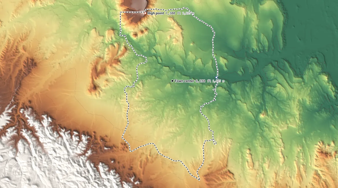 Topographic elevation map of Alamo, New Mexico, shaded from 6,000 ft on the east side to 7,300 ft on the north side