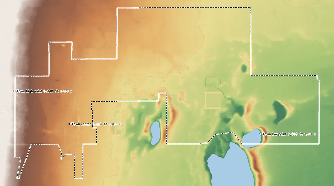 Topographic elevation map of Estancia, New Mexico, shaded from 6,080 ft on the east side to 6,140 ft on the northwest side
