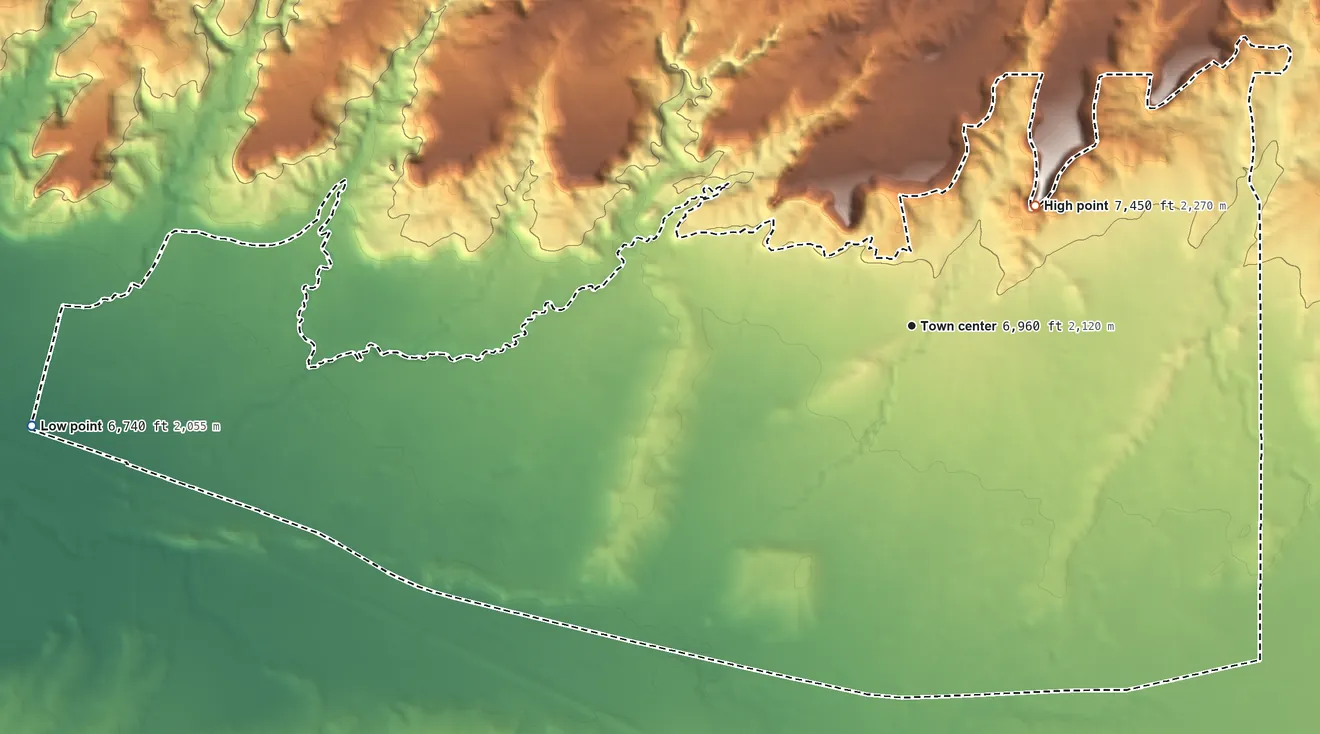 Topographic elevation map of Iyanbito, New Mexico, shaded from 6,740 ft on the west side to 7,450 ft on the northeast edge, below higher ground just outside
