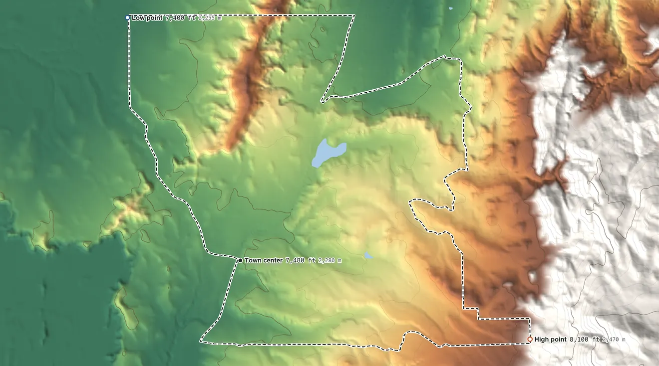 Topographic elevation map of Regina, New Mexico, shaded from 7,400 ft on the northwest side to 8,100 ft at the foot of the Badland Hills