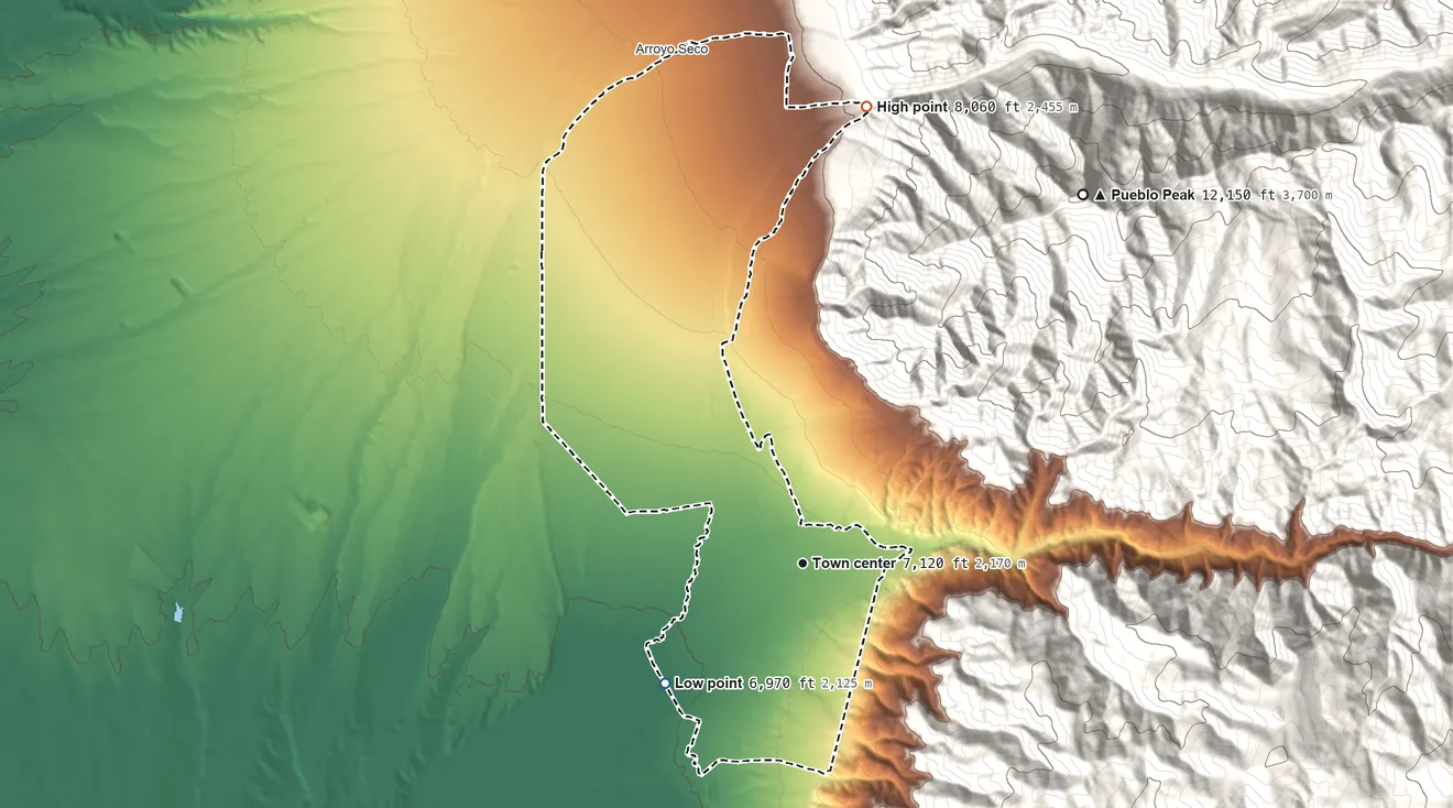 Topographic elevation map of Taos Pueblo, New Mexico, shaded from 6,970 ft on the southwest side to 8,060 ft on the north edge, below higher ground just outside