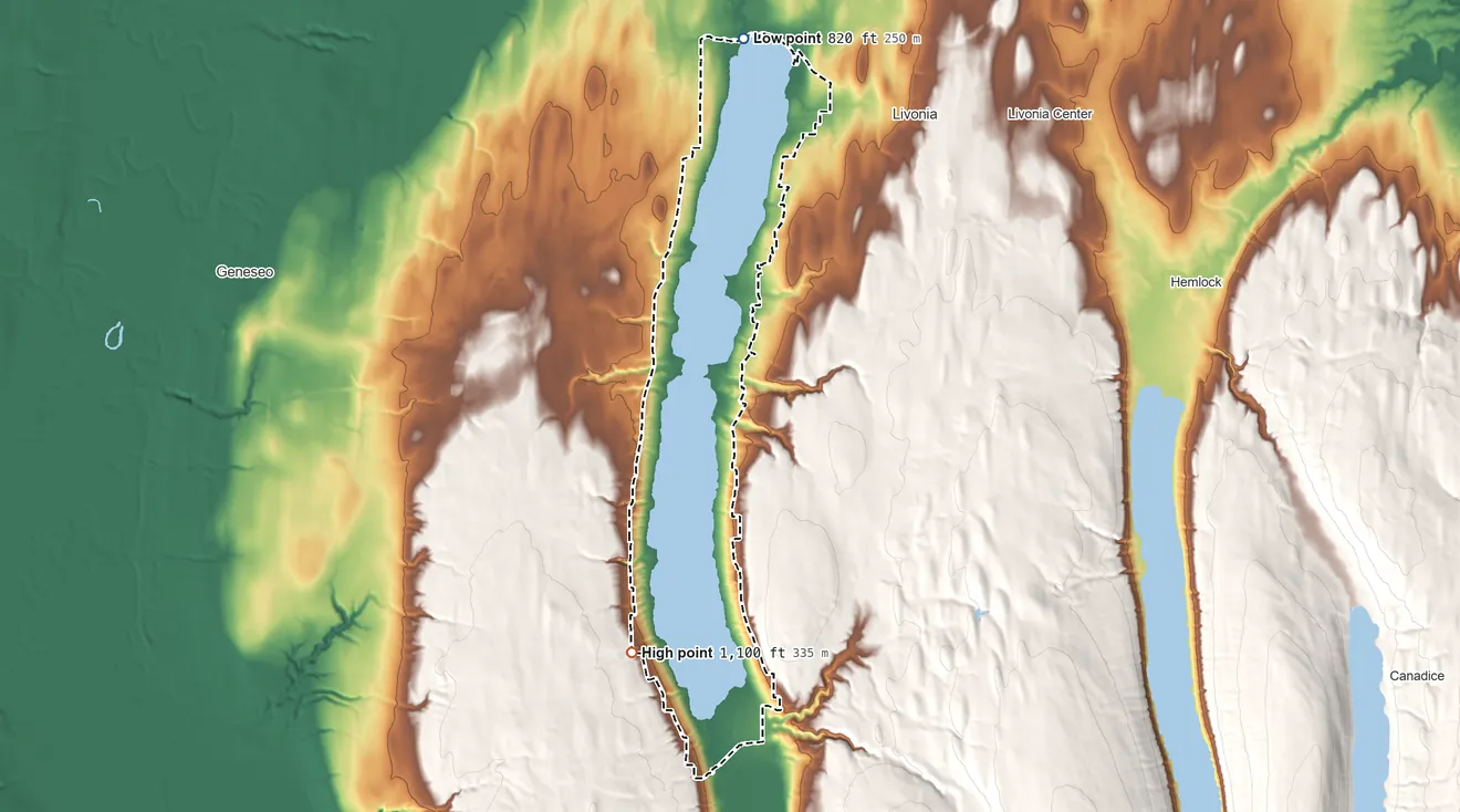 Topographic elevation map of Conesus Lake, New York, shaded from 820 ft on the north side to 1,100 ft on the south side