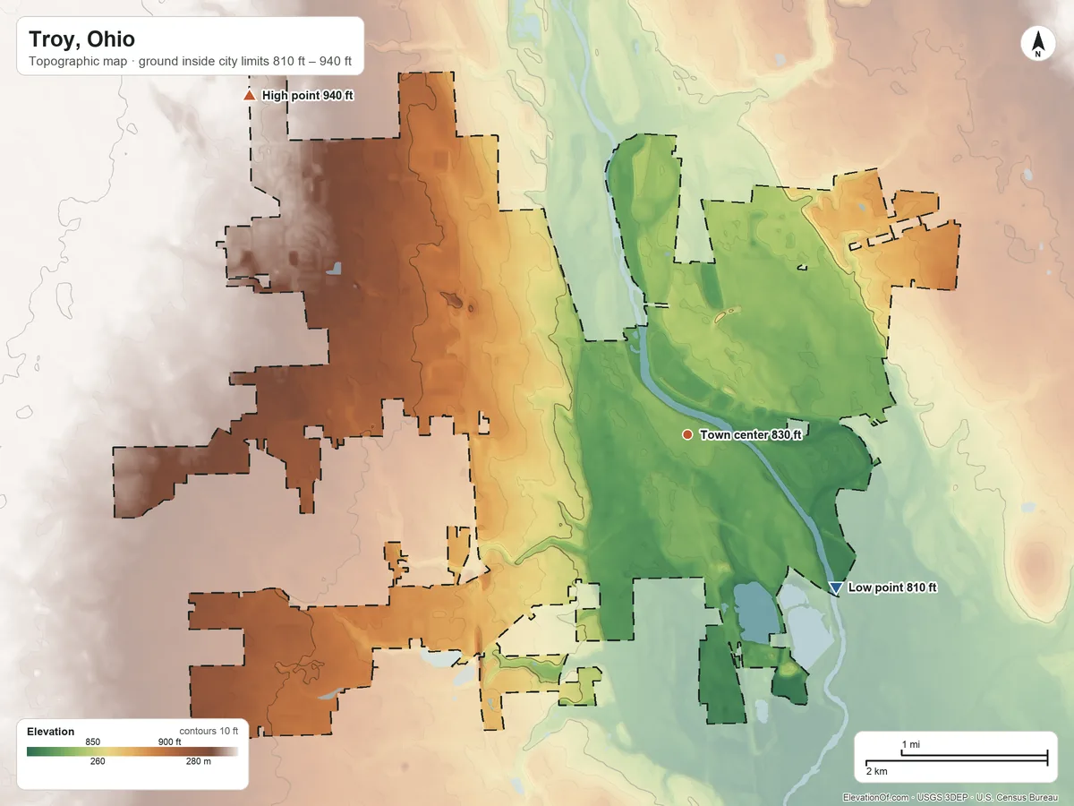 Topographic elevation map of Troy, Ohio, shaded from 810 ft on the southeast side to 940 ft on the northwest side