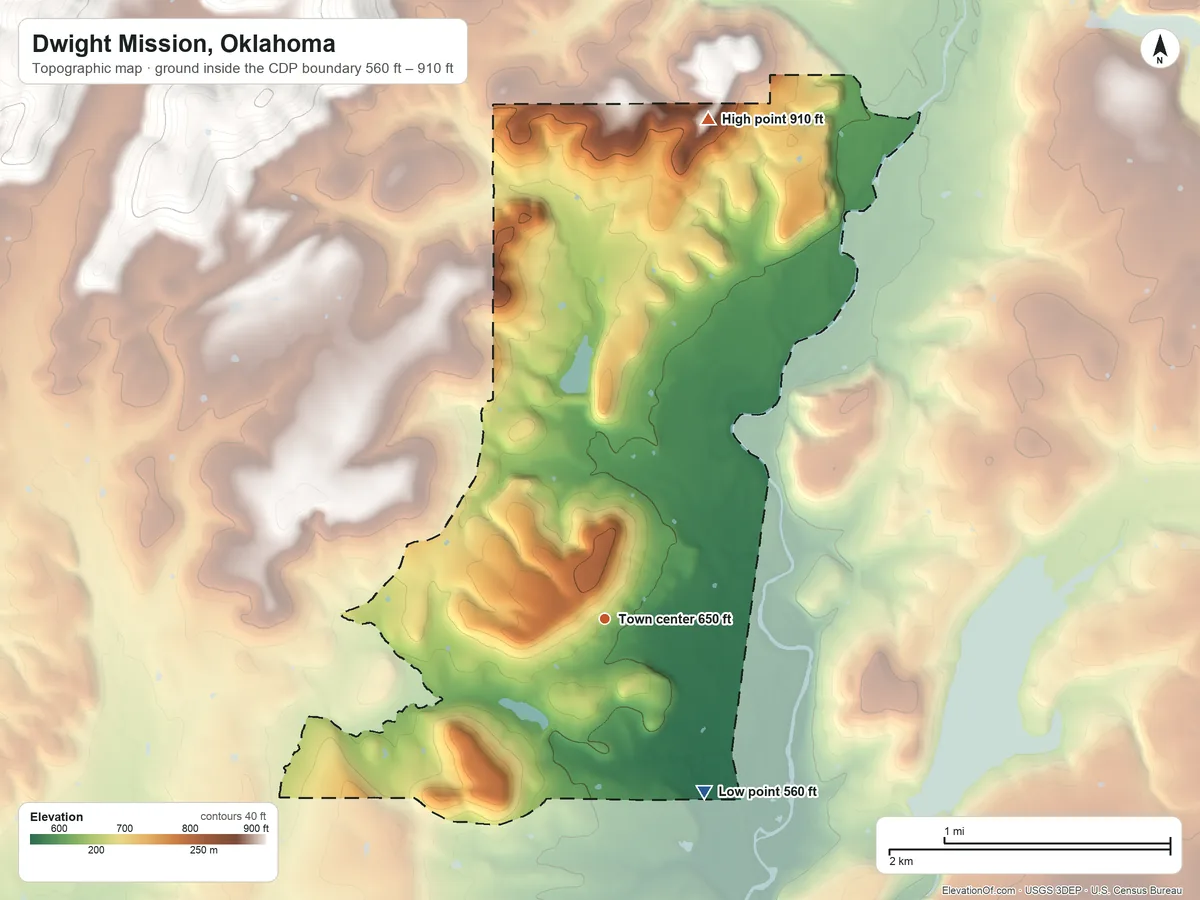 Topographic elevation map of Dwight Mission, Oklahoma, shaded from 560 ft on the southeast side to 910 ft at the foot of the Brushy Mountains