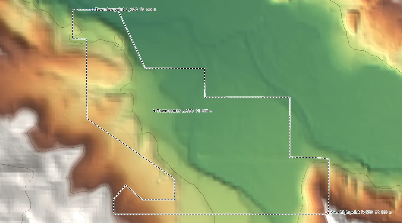 Topographic elevation map of Dayville, Oregon, shaded from 2,320 ft on the northwest side to 2,620 ft on the southeast edge, below higher ground just outside
