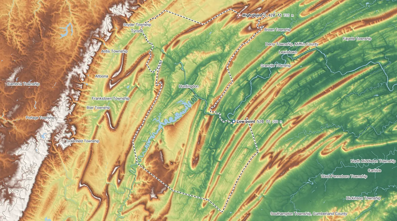 Topographic elevation map of Huntingdon County, Pennsylvania, shaded from 520 ft on the east side to 2,420 ft on Greenlee Mountain