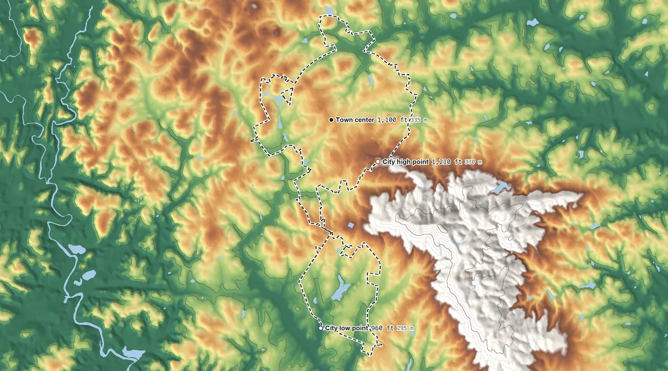 Topographic elevation map of Travelers Rest, South Carolina, shaded from 960 ft on the south side to 1,210 ft at the foot of the Saluda Mountains