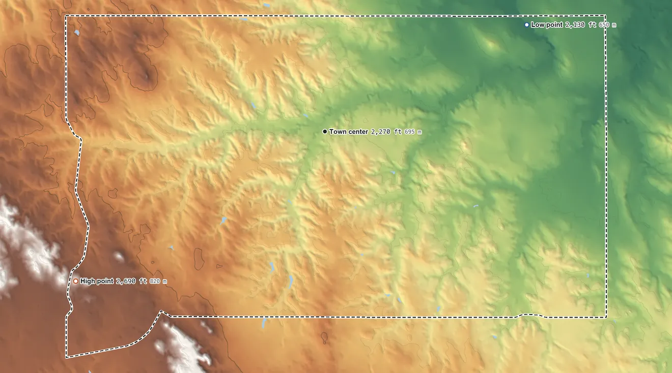 Topographic elevation map of Okreek, South Dakota, shaded from 2,130 ft on the northeast side to 2,690 ft on the southwest side