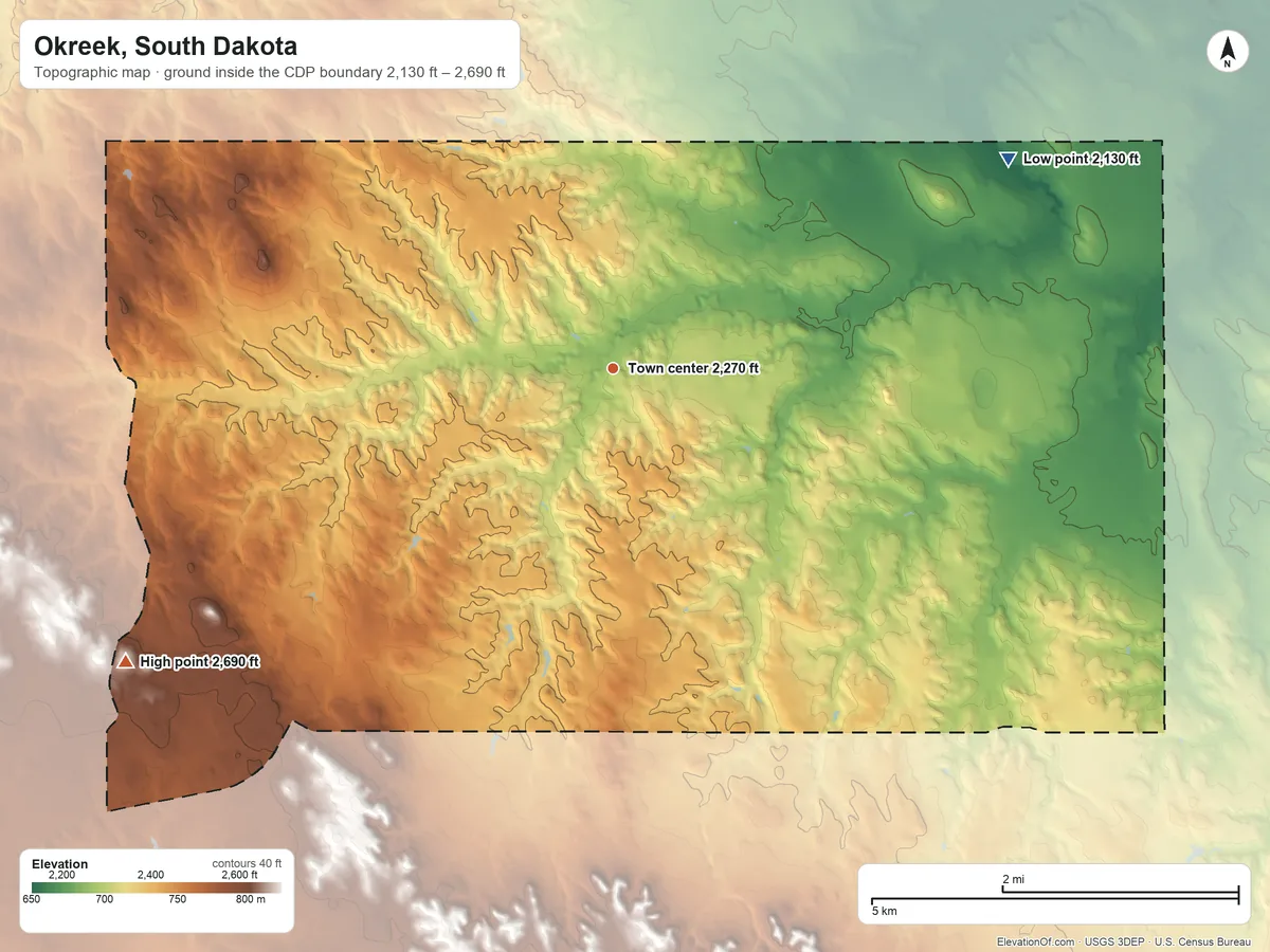 Topographic elevation map of Okreek, South Dakota, shaded from 2,130 ft on the northeast side to 2,690 ft on the southwest side