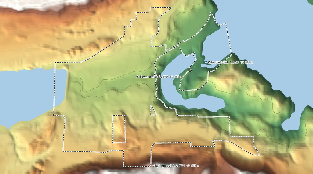 Topographic elevation map of Grand Coulee, Washington, shaded from 1,250 ft on the east side to 2,210 ft on the south side
