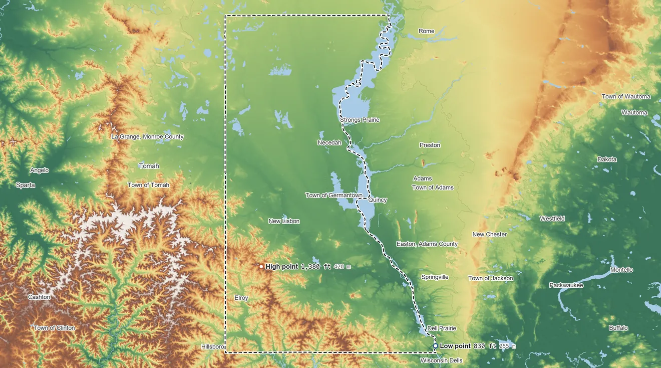 Topographic elevation map of Juneau County, Wisconsin, shaded from 830 ft on the southeast side to 1,380 ft on Johnson Hill