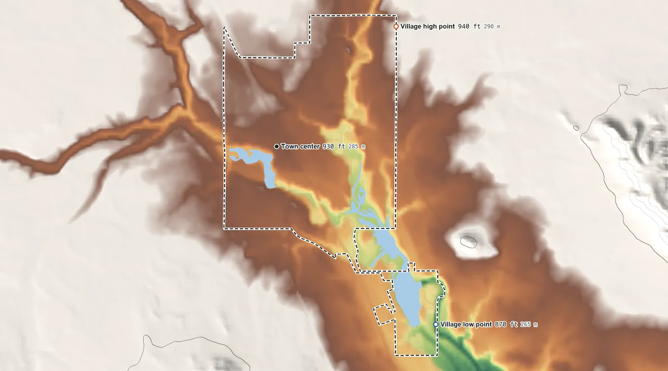 Topographic elevation map of Merrillan, Wisconsin, shaded from 870 ft on the southeast side to 940 ft at the foot of the Seven Points