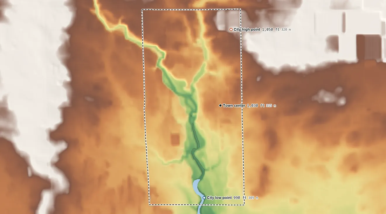 Topographic elevation map of Pittsville, Wisconsin, shaded from 990 ft on the south side to 1,050 ft on the north side