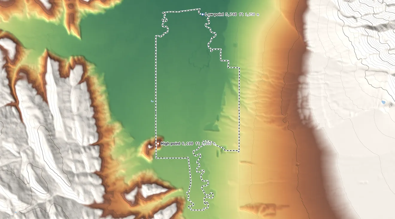 Topographic elevation map of Freedom, Wyoming, shaded from 5,740 ft on the northeast side to 6,100 ft on the south edge, below higher ground just outside